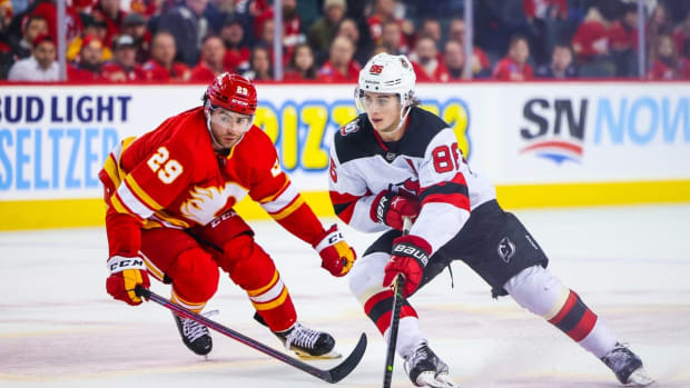 Nov 5, 2022; Calgary, Alberta, CAN; New Jersey Devils center Jack Hughes (86) controls the puck against Calgary Flames center Dillon Dube (29) during the third period at Scotiabank Saddledome. Mandatory Credit: Sergei Belski-USA TODAY Sports
